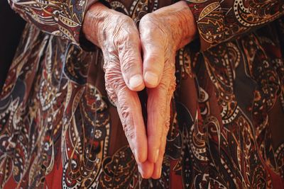 Midsection of woman with hands clasped