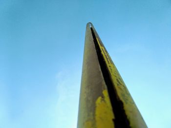 Low angle view of metallic structure against blue sky