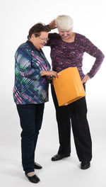 Couple standing against white background