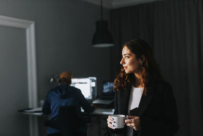 Young woman drinking coffee at home