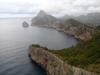 Scenic view of sea and mountains against sky