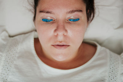 Close-up portrait of man relaxing on bed at home