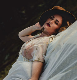 Portrait of a young woman sitting outdoors