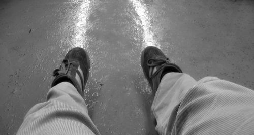 Low section of man standing in water