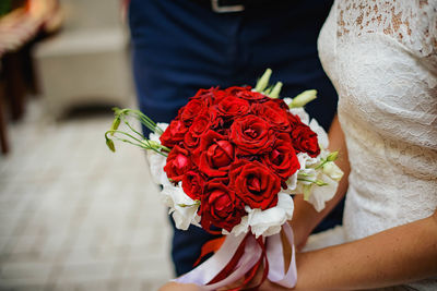 Close-up of hand holding rose bouquet