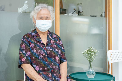 Portrait of young woman standing in bathroom