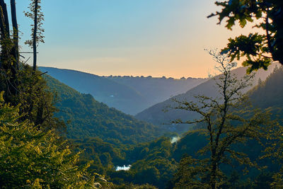 Scenic view of mountains against sky at sunset