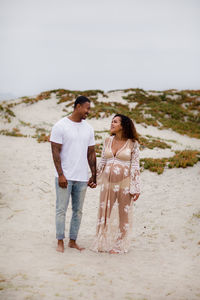 Friends standing on beach