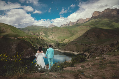 Rear view of woman walking on mountain