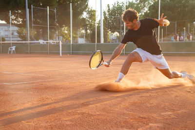 Full length of man playing tennis