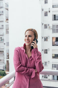 Portrait of a smiling young man using smart phone