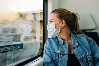 Woman looking through train window