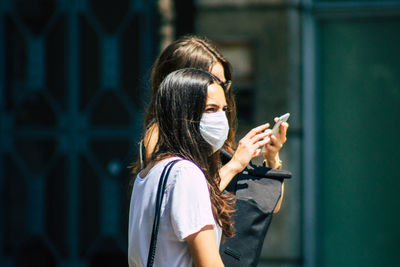 Midsection of woman using mobile phone