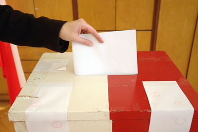 High angle view of hands holding paper