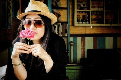 Full length portrait of woman holding flowers