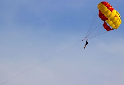 Low angle view of parachute against sky