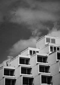 Low angle view of residential buildings against cloudy sky