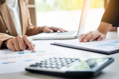 Close-up of woman working on table