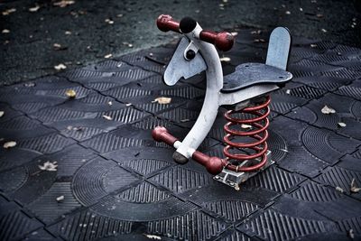 High angle view of toy bicycle on footpath