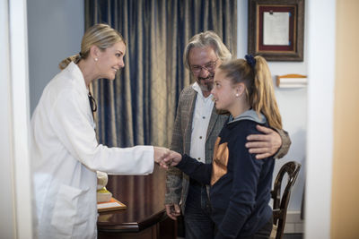 Doctor greeting patients in medical practice