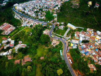 High angle view of street amidst houses and trees