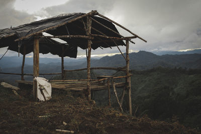 Abandoned hut on field against sky