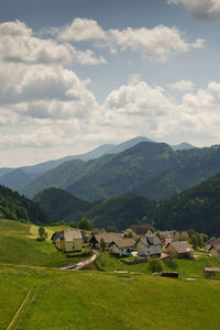 Scenic view of field and mountains against sky