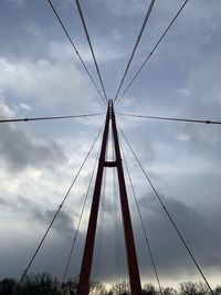 Low angle view of suspension bridge against sky