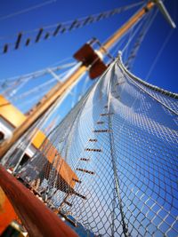 Low angle view of ropes against blue sky