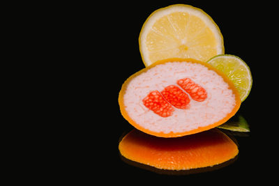 Close-up of lemon slice over black background