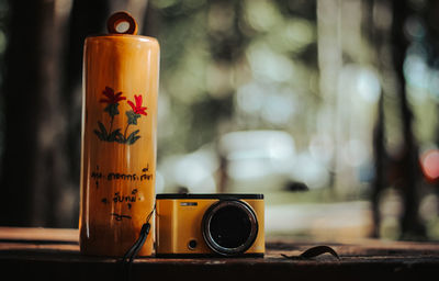 Close-up of camera and container on table