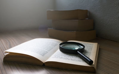 Close-up of open book on table at home