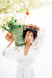 Portrait of young woman with bouquet