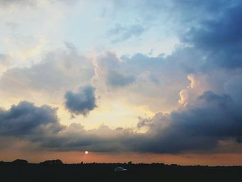 Scenic view of landscape against cloudy sky