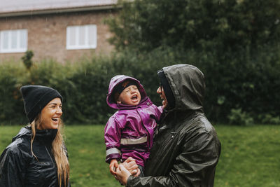 Portrait of mother and girl standing against plants