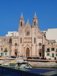 View of buildings against blue sky