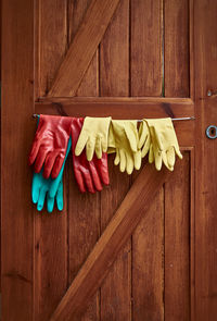 Gloves hanging on wooden door