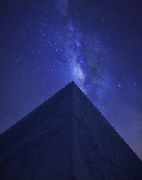 Low angle view of building against blue sky at night