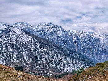 Scenic view of snowcapped mountains against sky