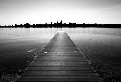 Pier over lake against sky