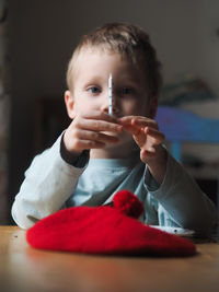 Portrait of boy holding candle at home