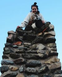 Low angle view of woman against clear sky