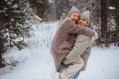 A couple in love walks in the forest in winter