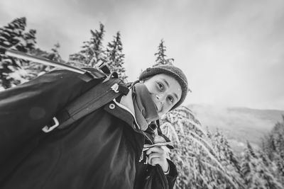 Low angle view portrait of young woman in manning park black and white