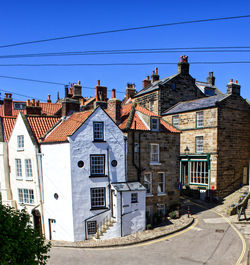 Residential buildings against blue sky