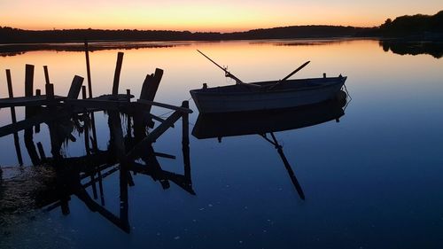 Fishing boat in lake at sunset