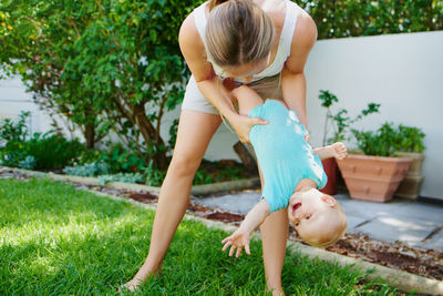 Rear view of woman sitting on grass