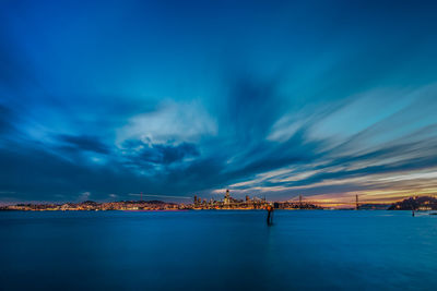 Scenic view of sea against blue sky at night