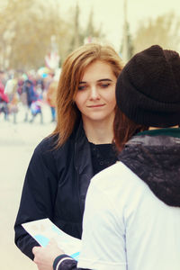 Portrait of beautiful young woman in hat