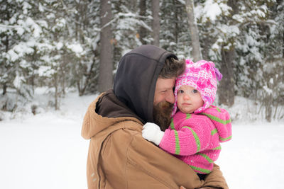 Close-up of father with baby in winter
